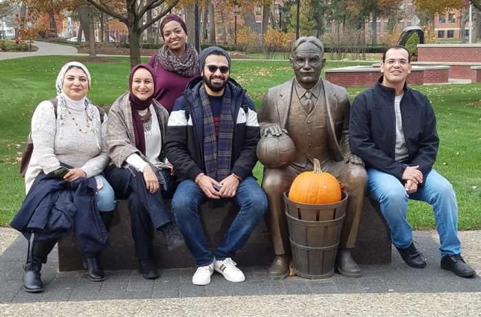 IVLP participants from Egypt pose with a statue of James Naismith