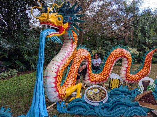 Colorful blue, yellow, and red dragon sculpture installation in New Orleans garden.
