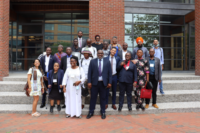 Group of IVLP participants smiling in a group photo on brick steps