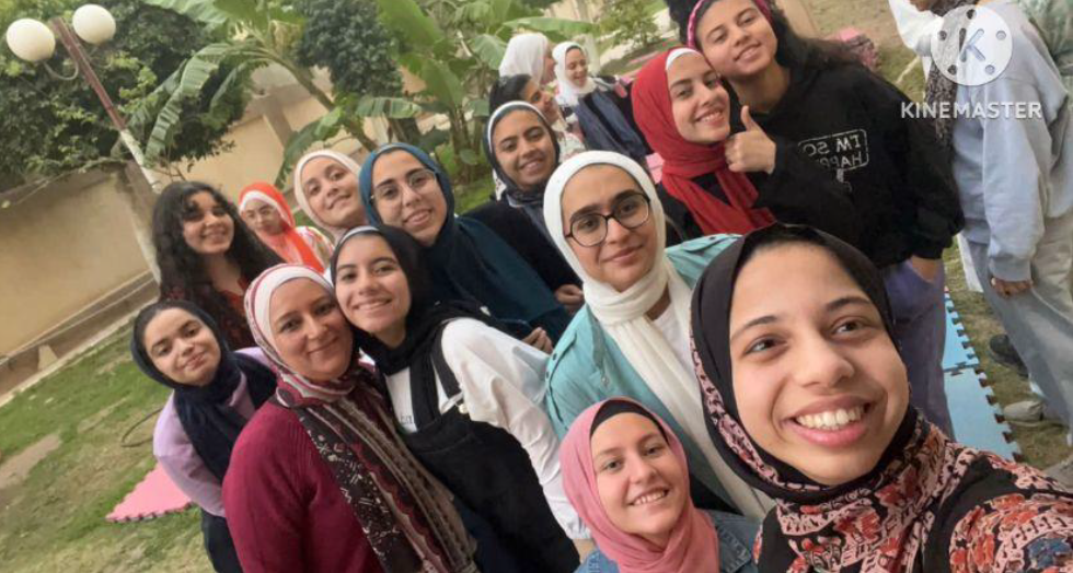 A selfie of a group of smiling girls standing outdoors in Egypt.
