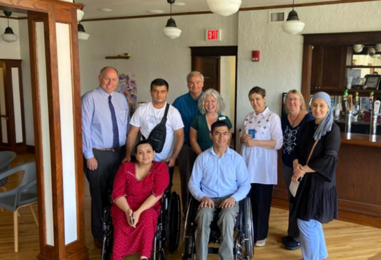 Group of a half-dozen people posed for a picture.