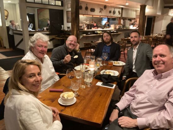 Group of people seated around a table.